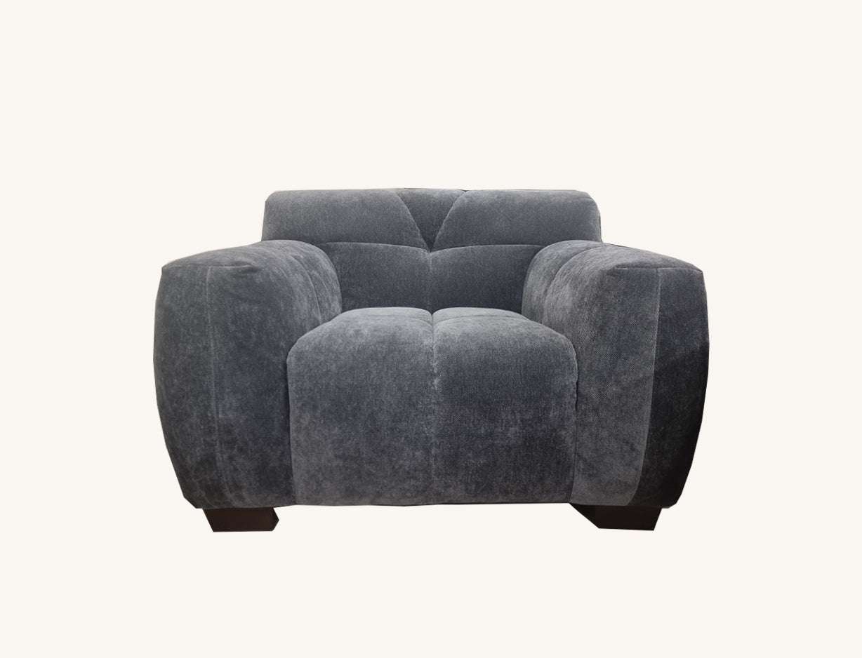 Aluxo Harlem Sofa Range in Steel Velvet featuring a stylish armchair design with a soft textured boucle fabric, ideal for relaxing.