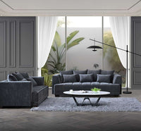 Stylish living room featuring the Aluxo Gramercy Group sofa in steel velvet, surrounded by elegant decor and natural light.