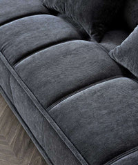 Close-up of the Aluxo Gramercy sofa in Steel Velvet, highlighting the luxurious fabric texture and tufted seat cushions for a comfortable and elegant look.