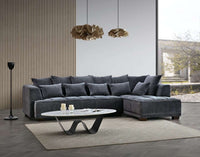 The Aluxo Gramercy Group in Steel Velvet, featuring a spacious sectional sofa with soft cushions, set in a modern living room with stylish decor.