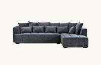 Front view of the Aluxo Gramercy Group sofa in steel velvet, featuring a modern design with numerous soft cushions for relaxation.