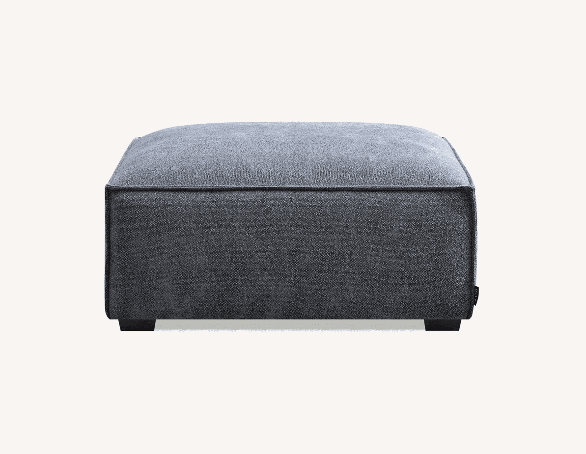 Front view of the Aluxo Dakota footstool in Charcoal Boucle, featuring a soft, padded top for added comfort.