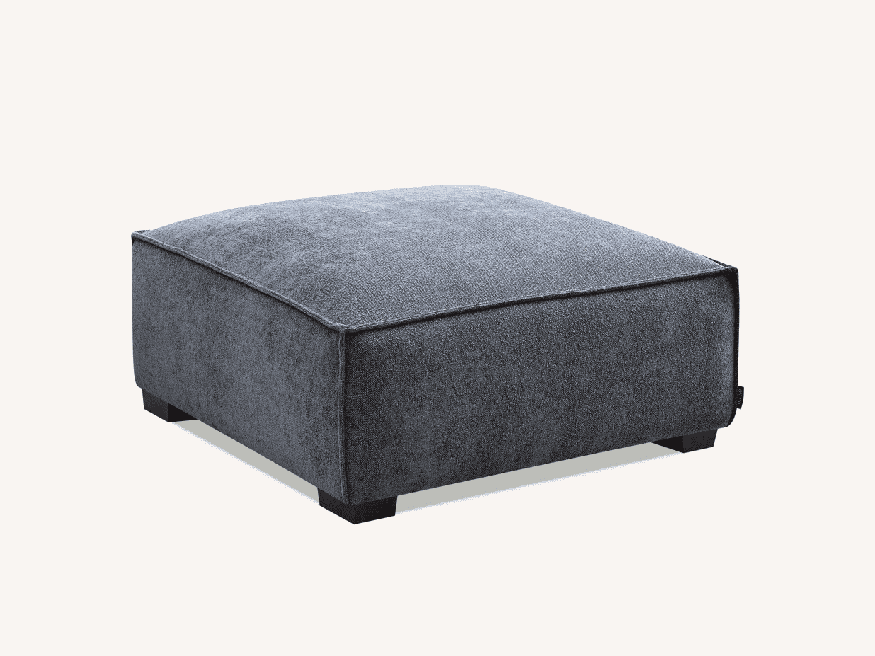 Side angle of the Aluxo Dakota footstool in Charcoal Boucle, designed with a contemporary appearance and textured fabric.