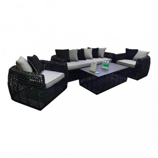 Millan Luxury Rattan 4-Piece Sofa Set by LISF LTD., featuring a modern design with plush cushions, stylish black rattan seating, and an elegant coffee table.