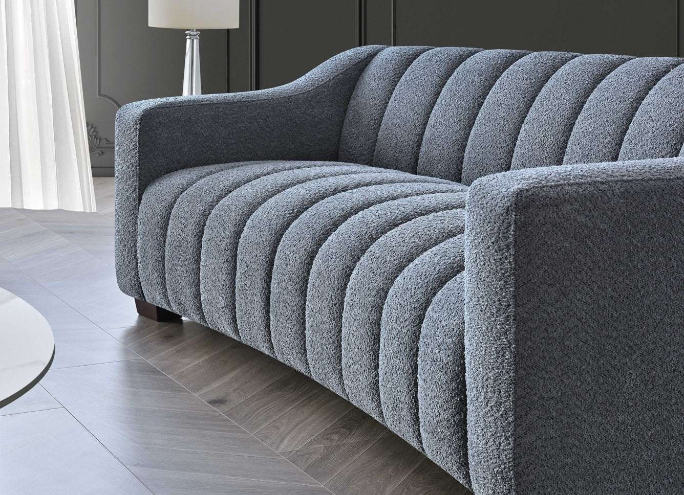 Aluxo Astoria 3 Seater Sofa in Iron Boucle Fabric - UK Luxury FurnitureAluxo Astoria 3 Seater Sofa in Iron Boucle FabricSofasAluxoUK Luxury Furniture8746763183897150952736538971Close - up of Aluxo Astoria 3 Seater Sofa in Iron Boucle Fabric, highlighting the plush fabric and intricate channel stitching that combine comfort and elegance in luxury furniture.