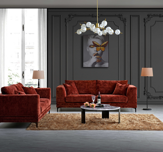 Stylish Aluxo Lenox Sofa Range in Rust Velvet set in a contemporary living room, featuring a coffee table, elegant lighting, and modern decor.