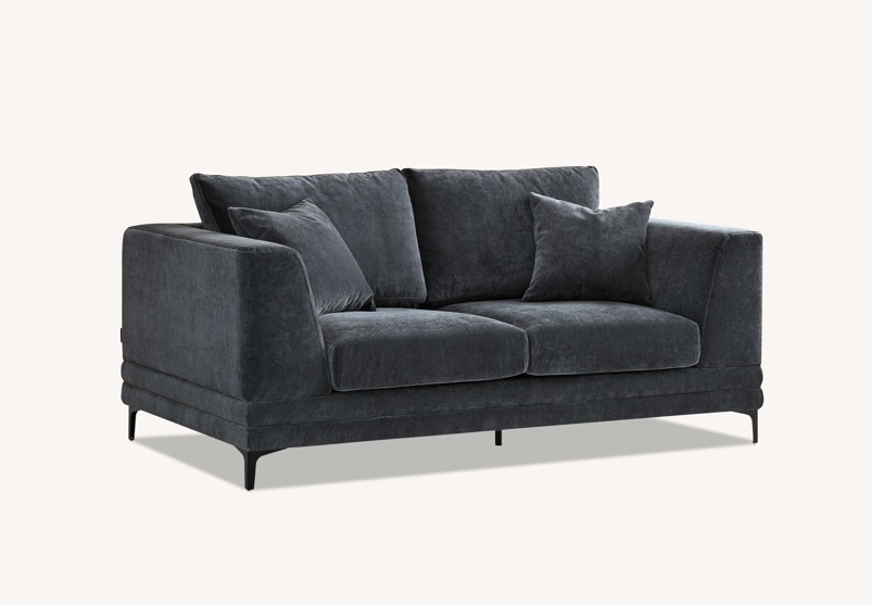 Angle view of the Aluxo Lenox Sofa Range in Steel Velvet, emphasizing its elegant shape and comfort in a contemporary decor.