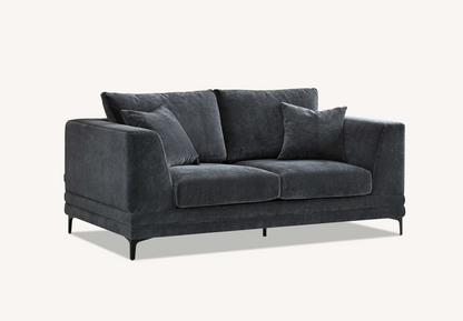 Angle view of the Aluxo Lenox Sofa Range in Steel Velvet, emphasizing its elegant shape and comfort in a contemporary decor.