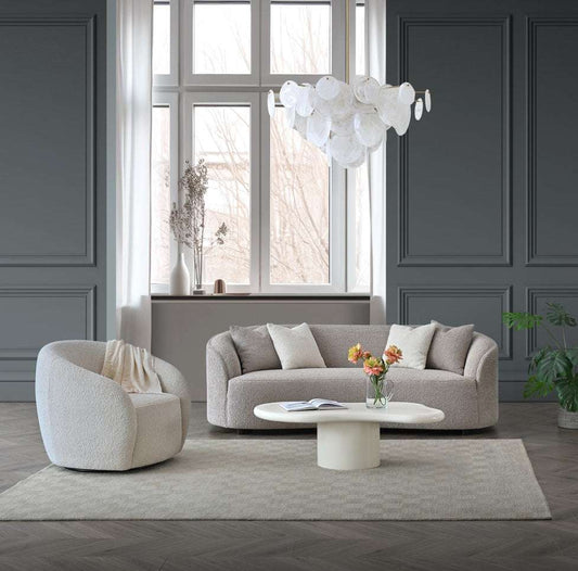 Stylish living room featuring the Aluxo Nolita Boucle Teddy Sofa with accent chair, showcasing soft boucle fabric and neutral tones.