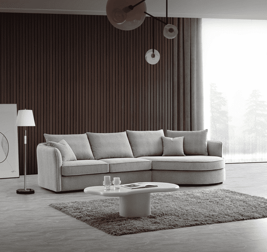Aluxo Rubin Corner Chaise in Pebble Boucle - UK Luxury FurnitureAluxo Rubin Corner Chaise in Pebble BoucleSofasAluxoUK Luxury Furniture8746763342831550952729428315Spacious living room featuring the Aluxo Rubin Corner Chaise in Pebble Boucle, designed for comfort with a curvy shape and soft fabric, complemented by modern decor elements.