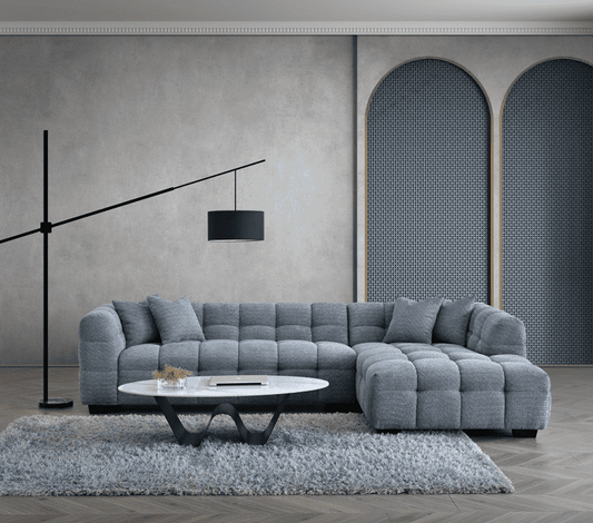 Aluxo Tribeca Corner Group in Iron Boucle Fabric showcased in a modern living room setting with a stylish floor lamp and textured wall features.