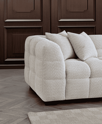 Aluxo Tribeca Right Hand Corner Group in Oatmeal Boucle Fabric - UK Luxury FurnitureAluxo Tribeca Right Hand Corner Group in Oatmeal Boucle FabricSofasAluxoUK Luxury Furniture8746763773429950952750334299Close - up view of the Aluxo Tribeca Right Hand Corner Group in Oatmeal Boucle Fabric, highlighting the plush cushioning and textured fabric against a sophisticated backdrop.