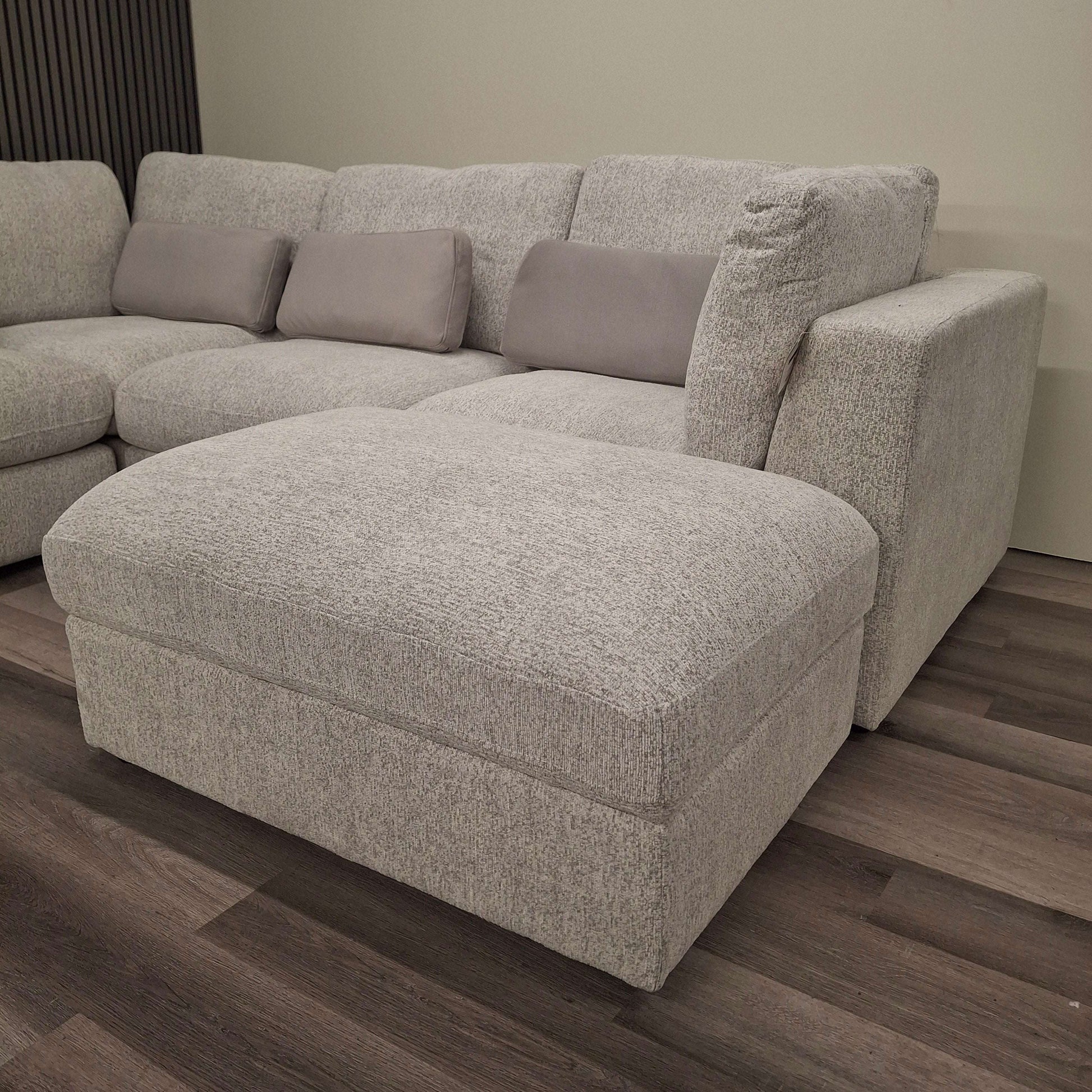 Textured light grey U-Shaped Madison Sofa by Furnish 365 Limited showcasing a cozy ottoman and stylish cushions.