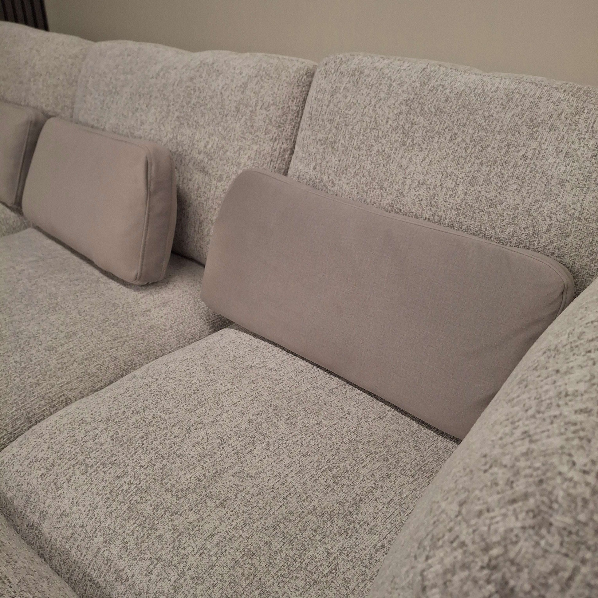 Close-up of the plush backrest and cushions of the U-Shaped Madison Sofa from Furnish 365 Limited in soft grey.