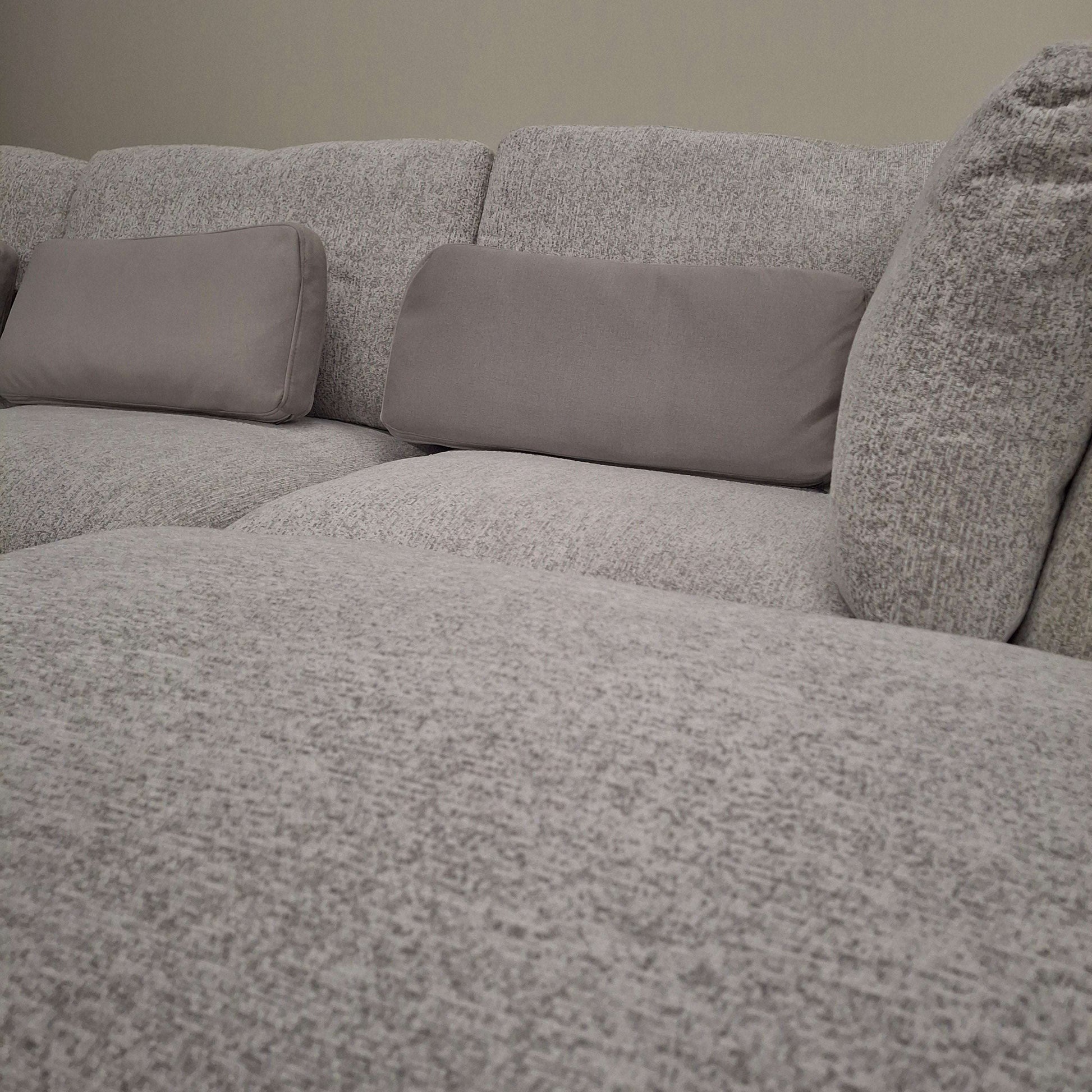 Close-up view of the Madison U Shape Sofa by Furnish 365 Limited, featuring soft grey fabric and supportive cushions for a cozy living space.