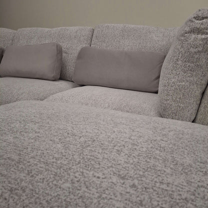 Close-up view of the Madison U Shape Sofa by Furnish 365 Limited, featuring soft grey fabric and supportive cushions for a cozy living space.