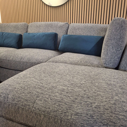 Detail shot of the Madison U Shape Sofa by Furnish 365 Limited, featuring plush cushions and a modern design, set against a stylish backdrop.