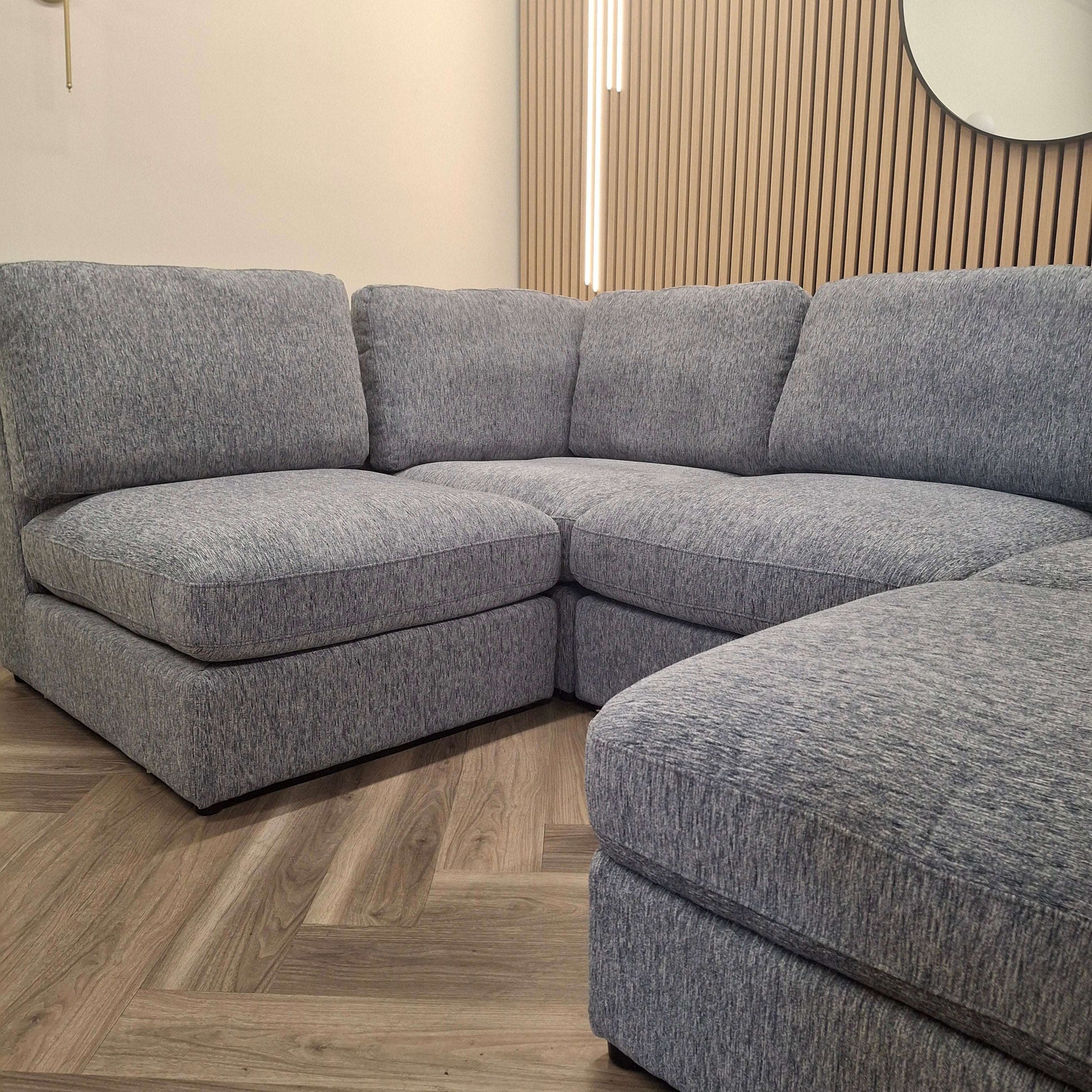 Close-up view of the Madison U Shape Sofa by Furnish 365 Limited, showcasing the comfortable cushioned seating and modern aesthetic in light grey.