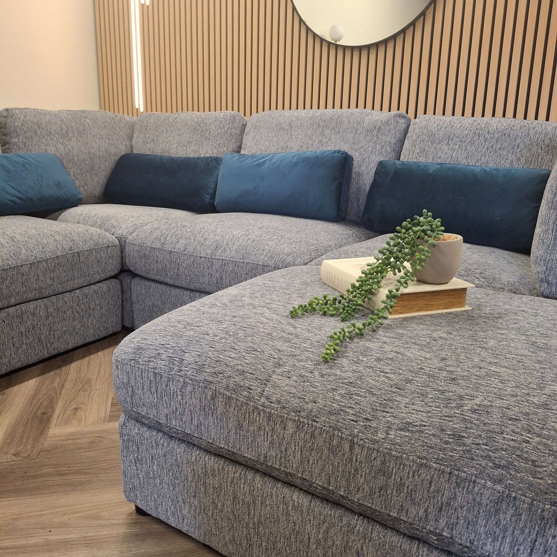 Stylish arrangement of the Madison U Shape Sofa by Furnish 365 Limited, adorned with decorative cushions and a small plant, perfect for contemporary living spaces.