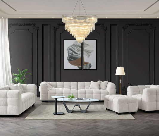 Spacious living room featuring the Tribeca Sofa Range in Oatmeal Boucle Fabric by Aluxo, set against a stylish dark wall with elegant decor including a chandelier and artwork.