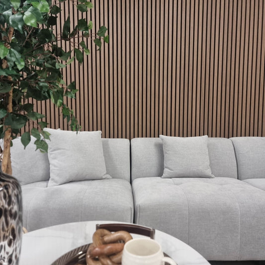Stylish living space showcasing Acoustic Wood Slatted Wall Panels from Furnish 365 Limited, featuring luxury furniture with grey sofa and greenery, enhancing the modern decor.